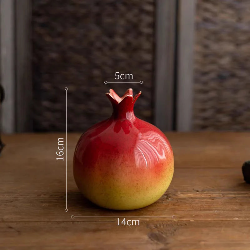 Decorative pomegranate-shaped vase with measurements on a wooden surface