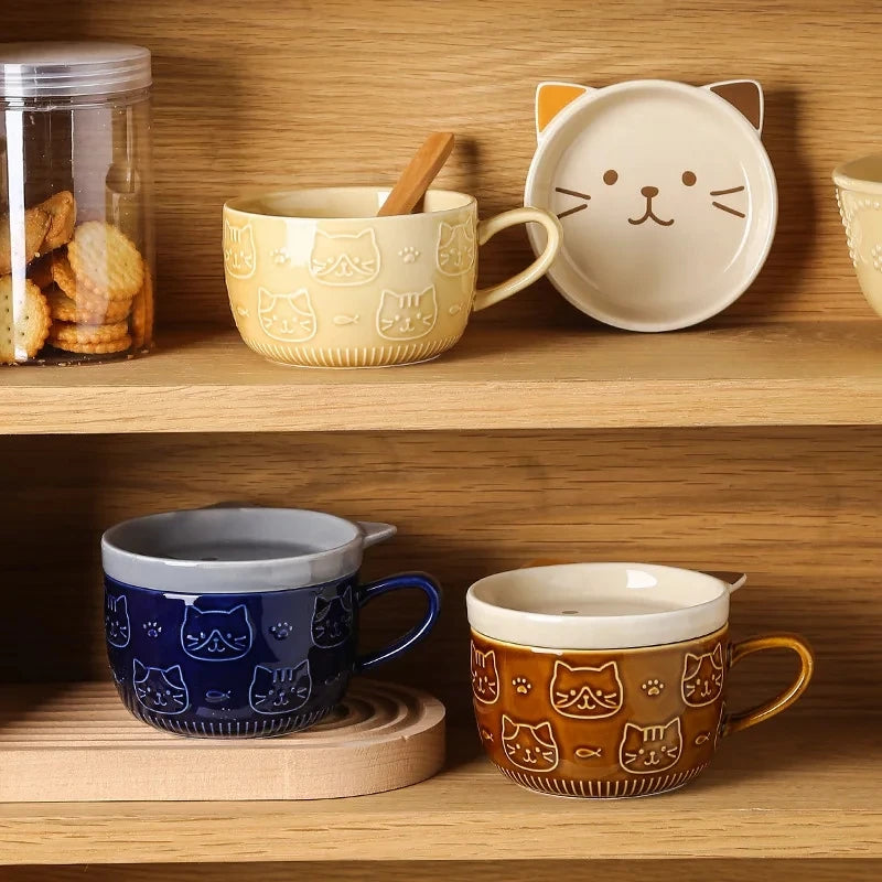 Cat-themed mugs and a bowl on a wooden shelf with cookies in the background.