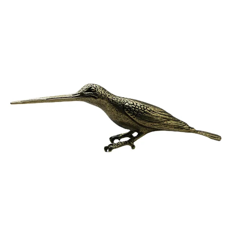 Bronze bird figurine on a white background