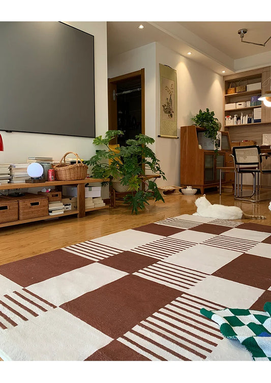 Living room with a patterned rug, furniture, and decor
