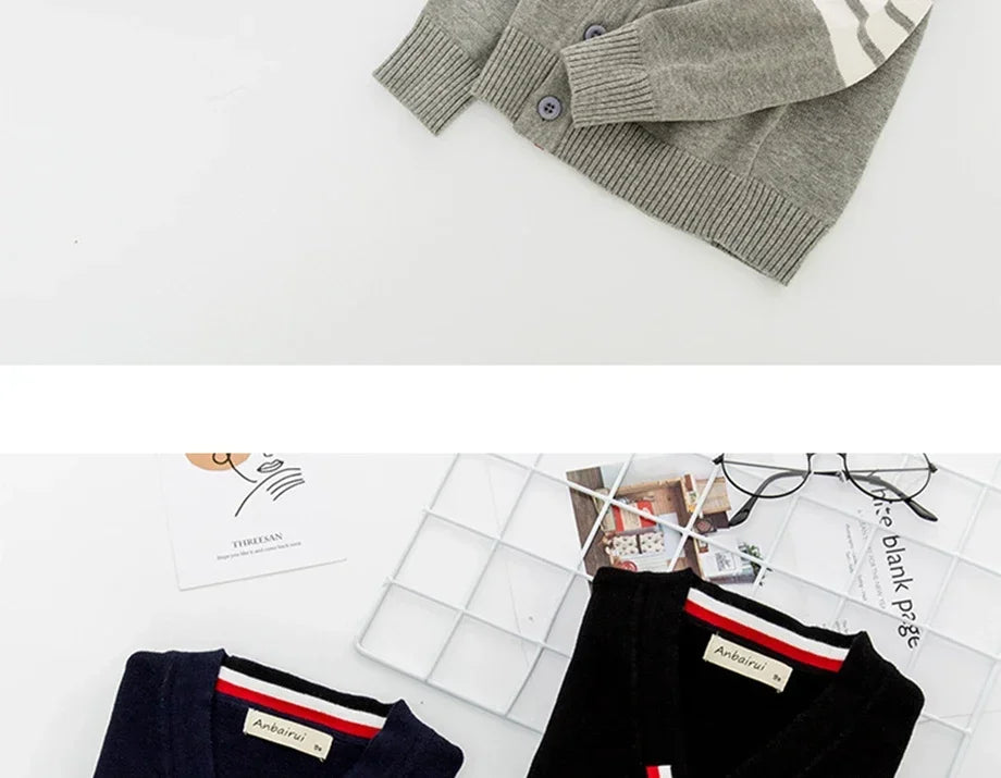 Knitted cardigan and pants with brand label on a white surface