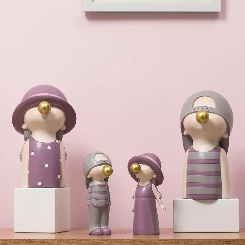 Set of decorative figurines with purple and gray outfits on a pink background blowing bubblegum