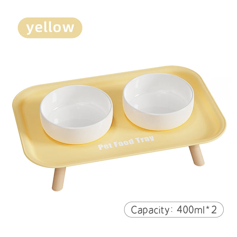Yellow pet food tray with two white bowls on a white background