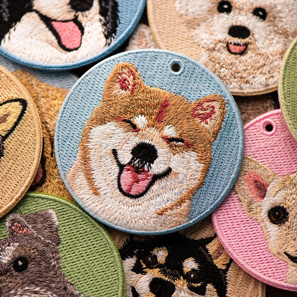 Collection of embroidered dog patches in various colors and designs.