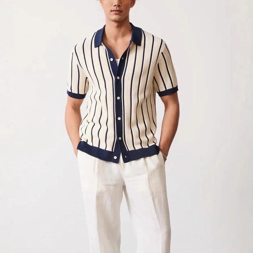 Man wearing a striped shirt with navy trim on a white background