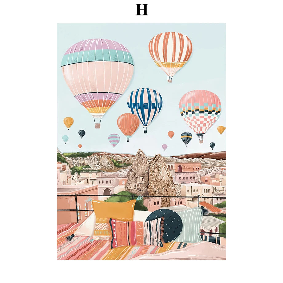 Colorful hot air balloons over a scenic landscape with buildings.