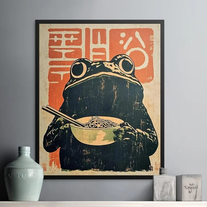Framed artwork of a frog eating noodles with chopsticks on a textured background.