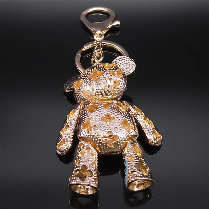 Gold teddy bear keychain on a black background