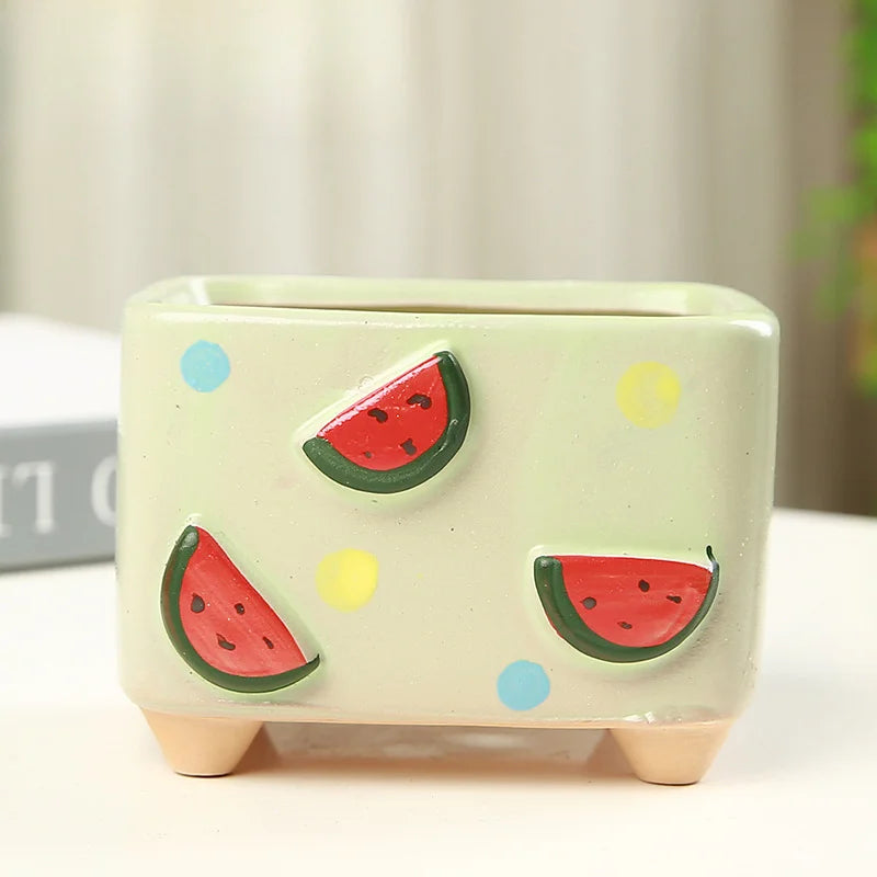 Small ceramic planter with watermelon design on a light background