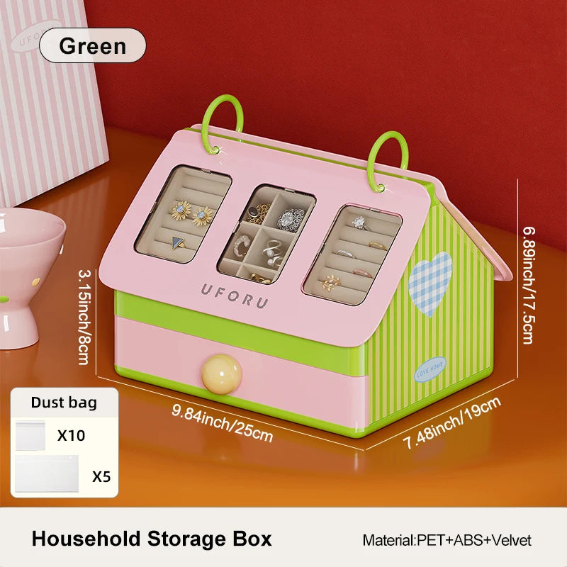Pink and green household storage box with compartments on a wooden surface.