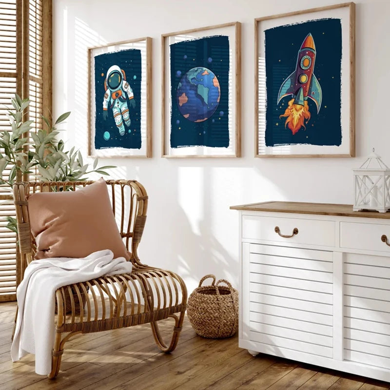Living room with a wicker chair, plant, and wall art featuring space-themed designs.