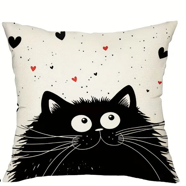 Pillow with a black cat illustration and heart patterns on a white background
