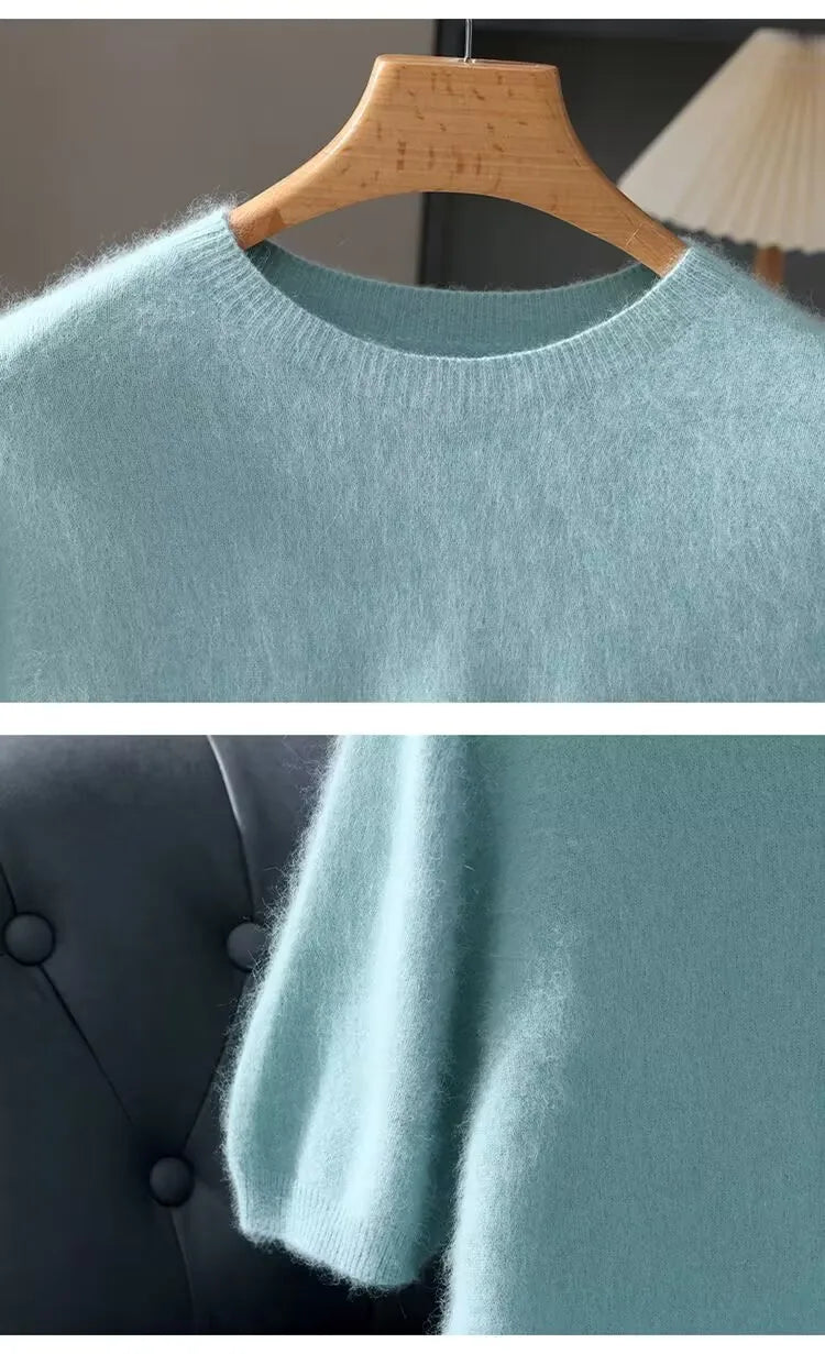 Light blue sweater on a wooden hanger against a neutral background