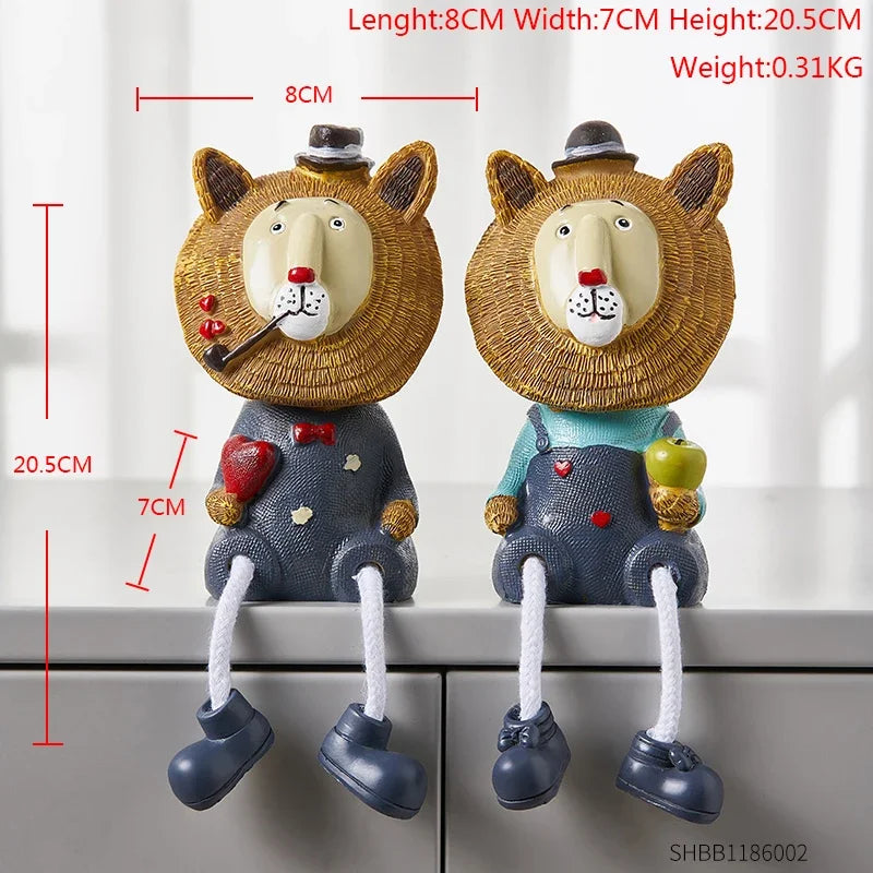 Two decorative lion figurines with measurements on a neutral background