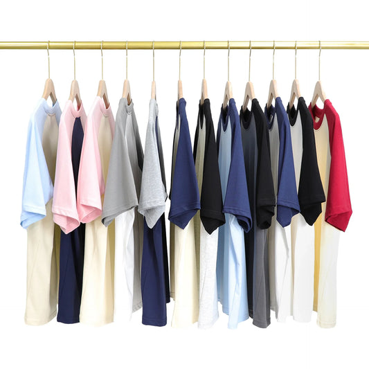 Row of colorful shirts on hangers against a white background