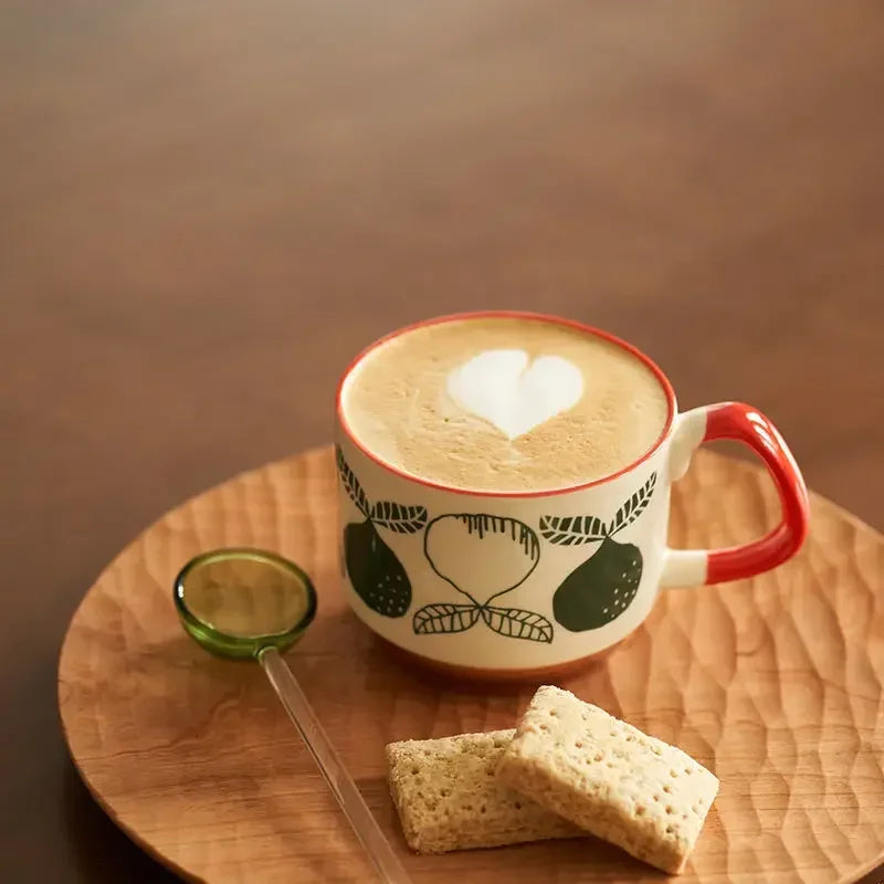 Cup of coffee with latte art on a wooden table with a lime and crackers.