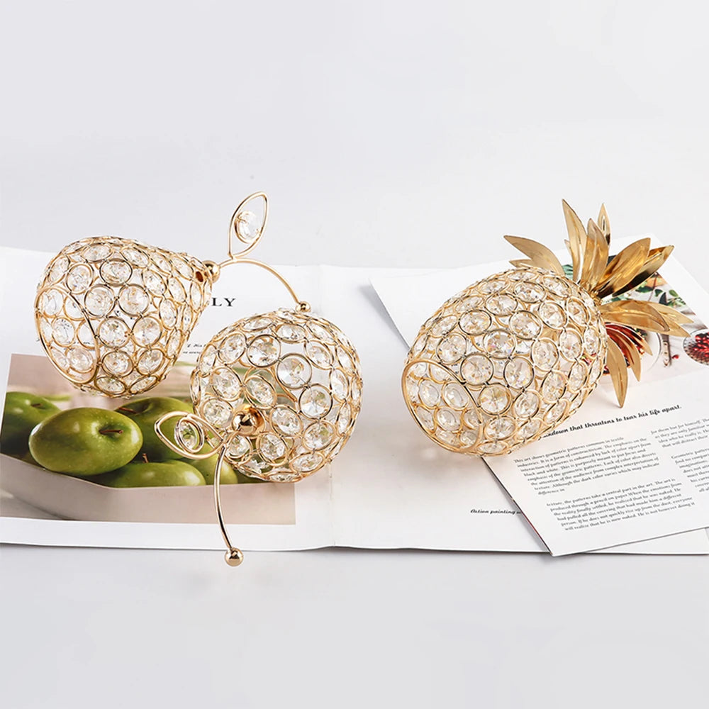 Decorative pineapple and pear-shaped crystal ornaments on a magazine