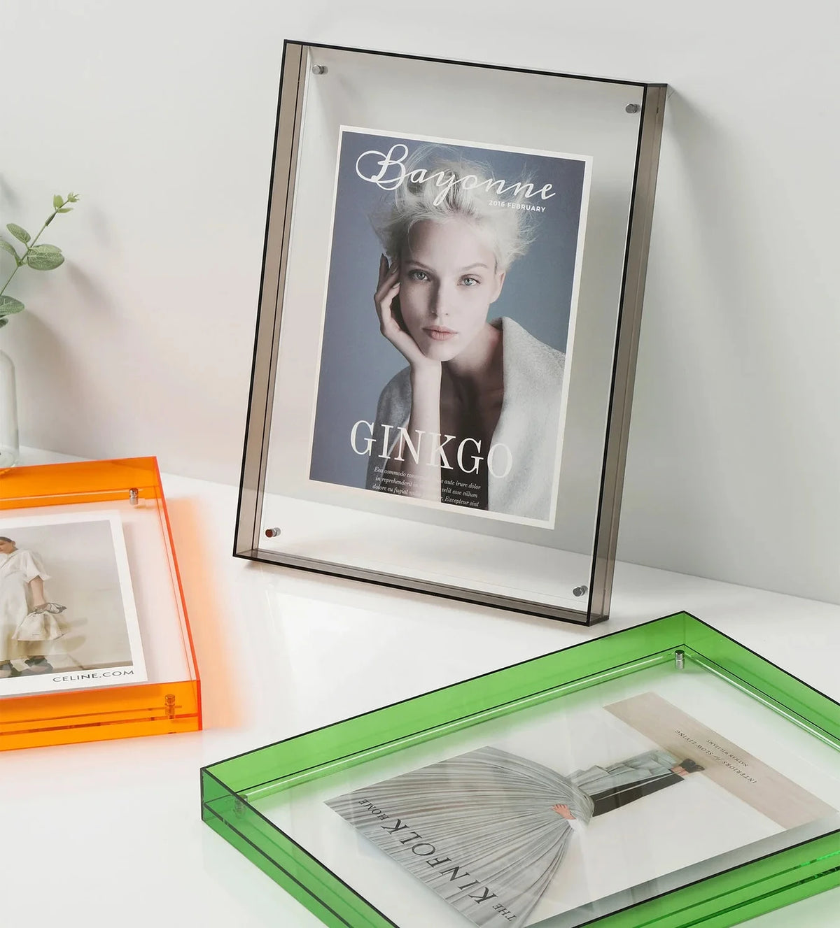 acrylic picture frames on a white surface with a neutral background
