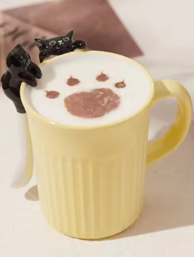 Green and yellow ceramic cat mugs with a 3D cat climbing over the rim.