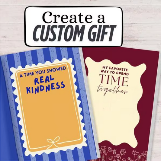 Two greeting cards with text on a wooden surface, with a sign above reading 'Create a Custom Gift'.