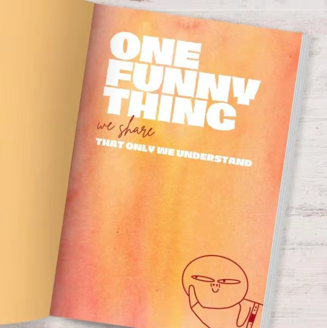 Book titled 'One Funny Thing We Share That Only We Understand' with a gradient cover and line drawing of a face.