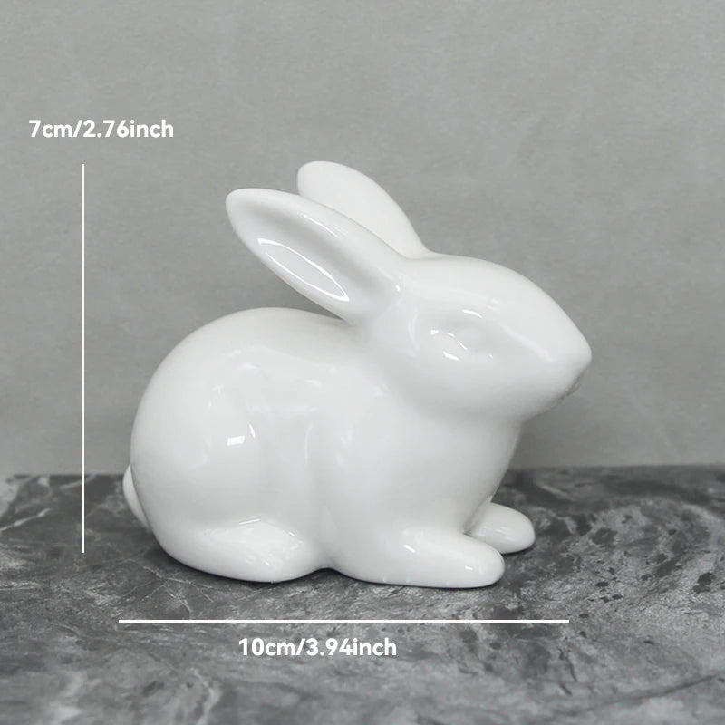 White ceramic rabbit figurine with measurements on a gray background