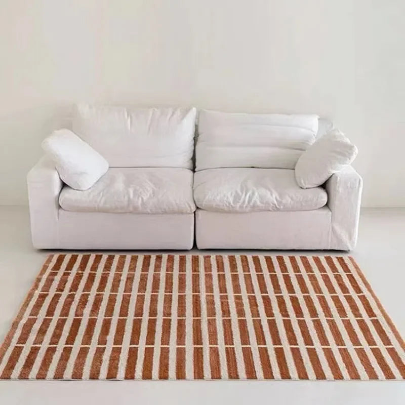 White sofa with white cushions on a plain background