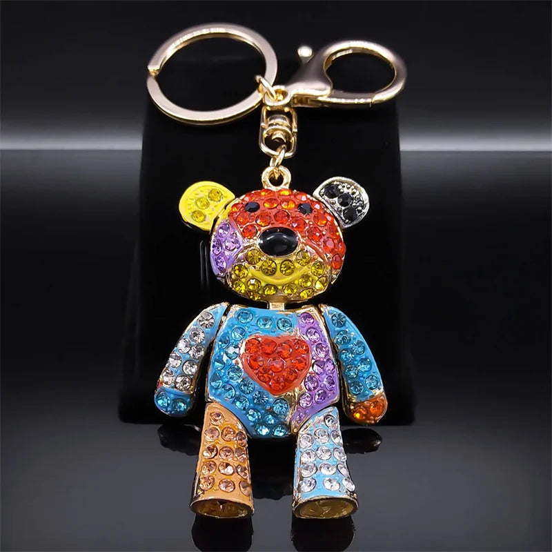 Colorful teddy bear keychain with rhinestones on a black background