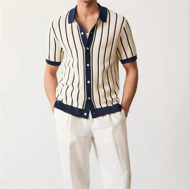 Person wearing a striped shirt with navy trim on a white background