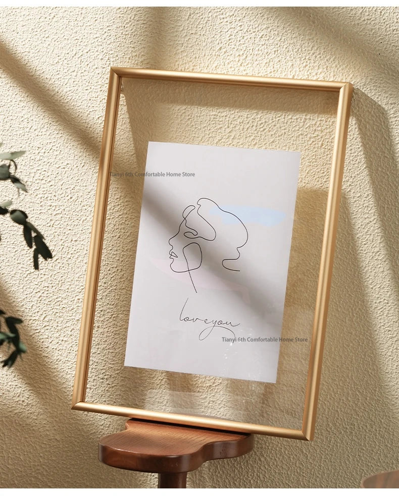 Wooden picture frame with a minimalist line art print of a woman's profile on a textured wall.
