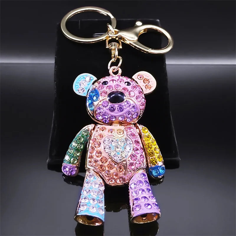 Colorful teddy bear keychain with rhinestones on a black stand