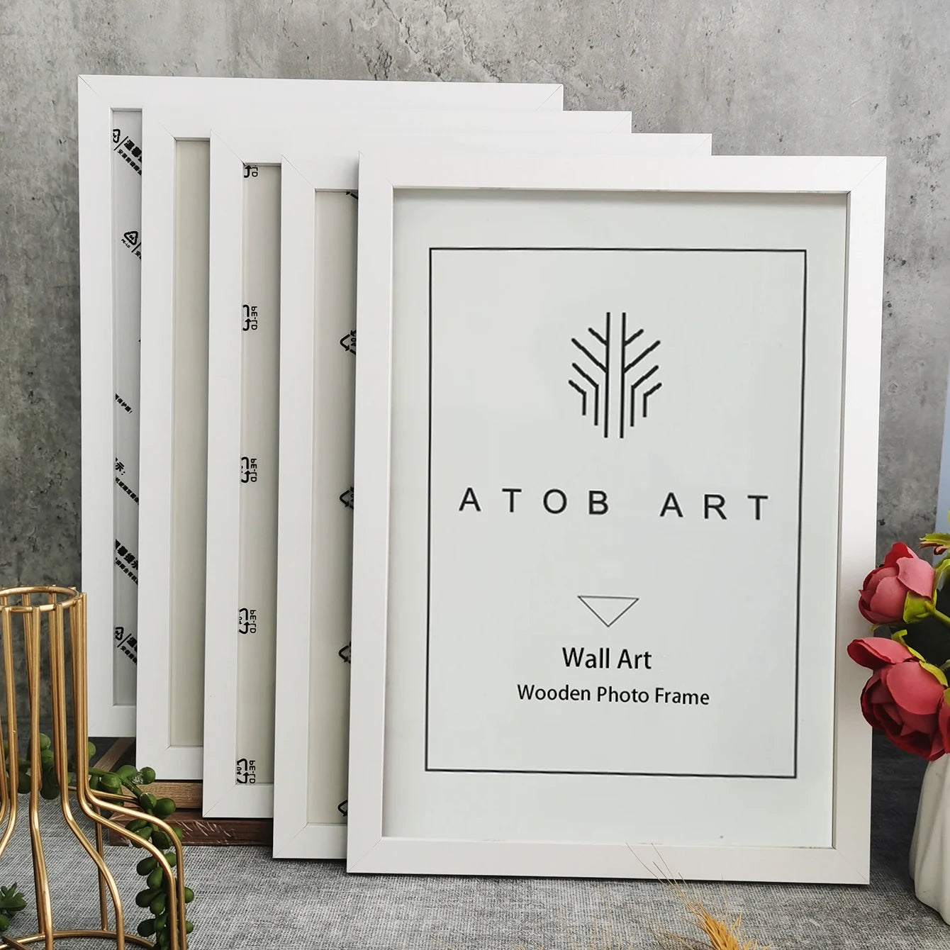 White photo frames with 'ATOB Art' branding on a gray surface.