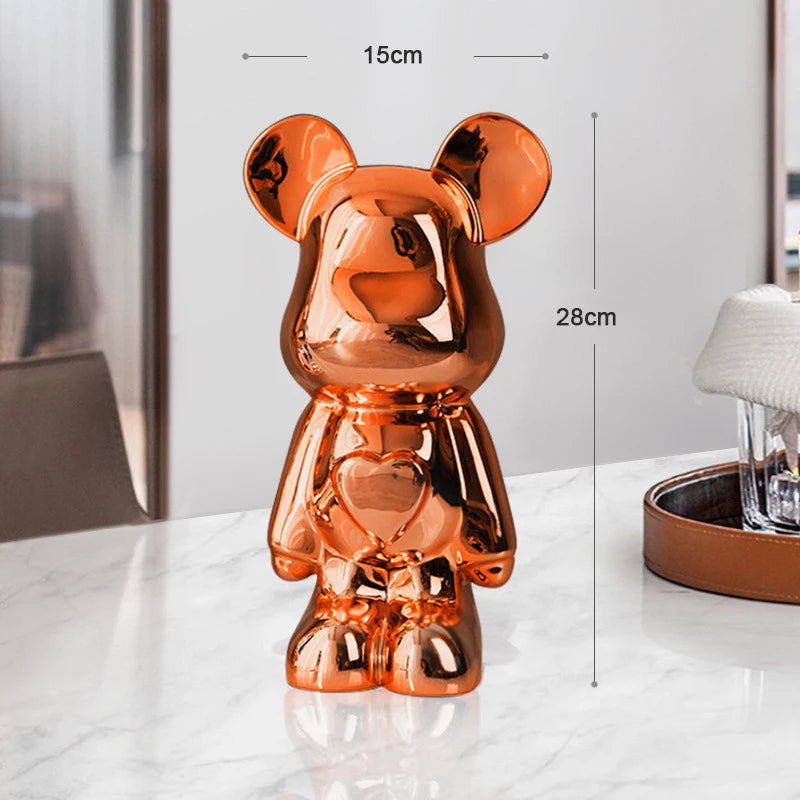 Copper-colored bear-shaped object on a white surface with measurements indicated.