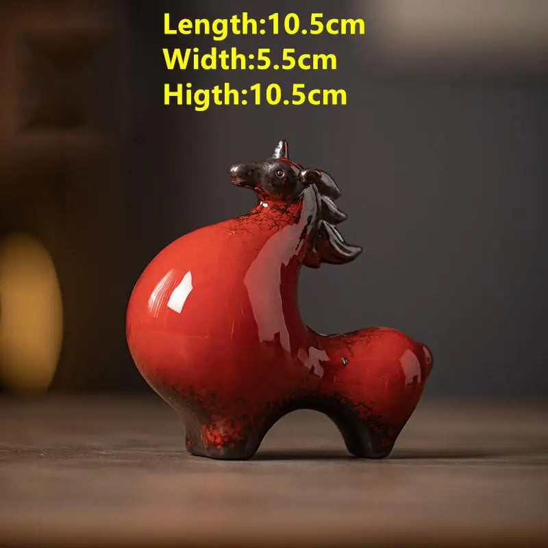 Red ceramic unicorn figurine with measurements on a dark background