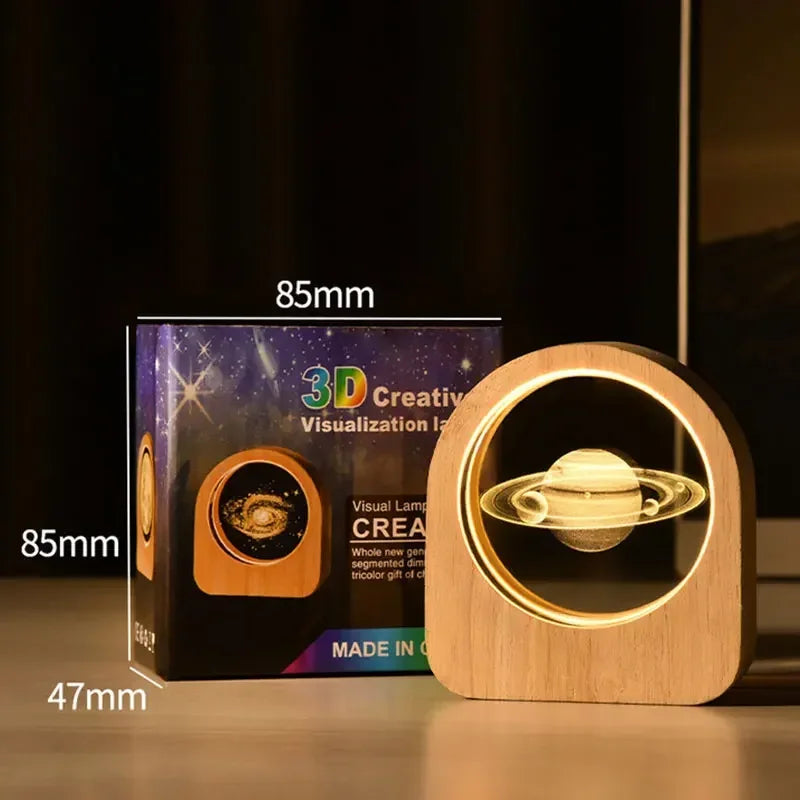 Glowing 3D Saturn model on a wooden base with packaging and measurements.