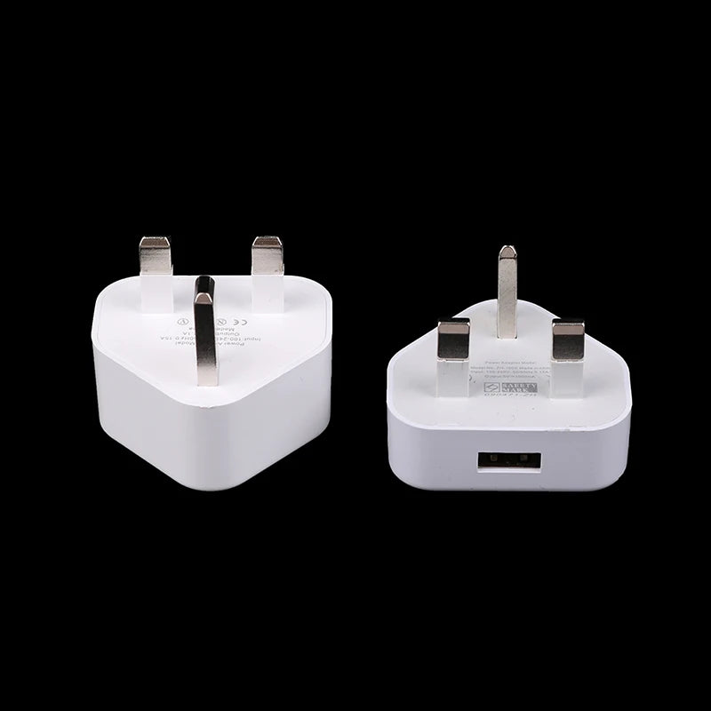 Two white plug adapters on a black background