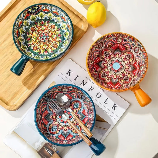 Hand-painted ceramic bowls with handles in colourful mandala-style patterns displayed on a table