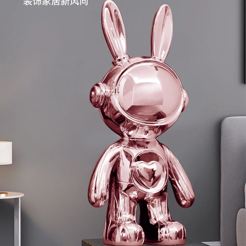Pink rabbit-shaped decorative object on a gray surface with a neutral background