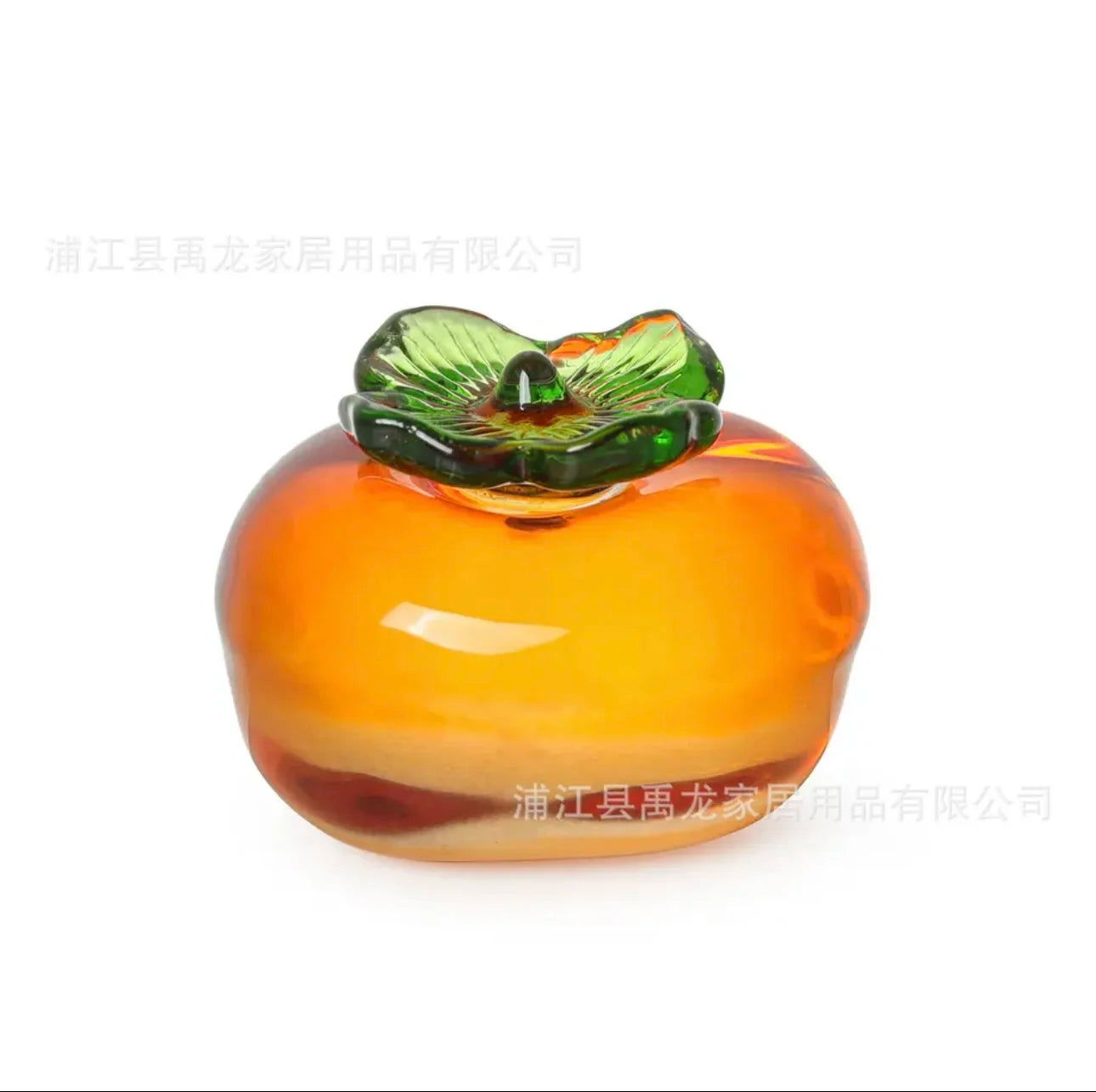 Glass fruit-shaped object with a green top on a white background