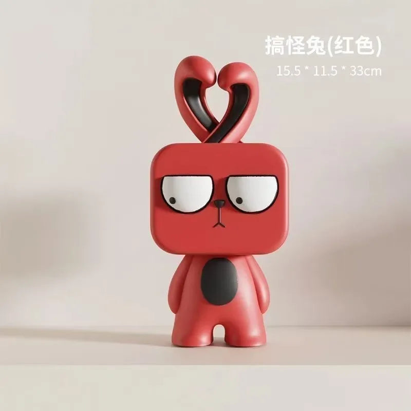 Red cartoon figurine with heart-shaped ears on a beige background
