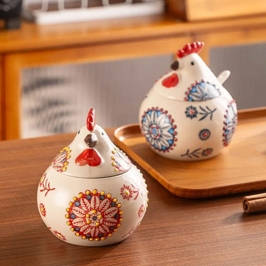 Two decorative ceramic chicken-shaped containers on a wooden surface.