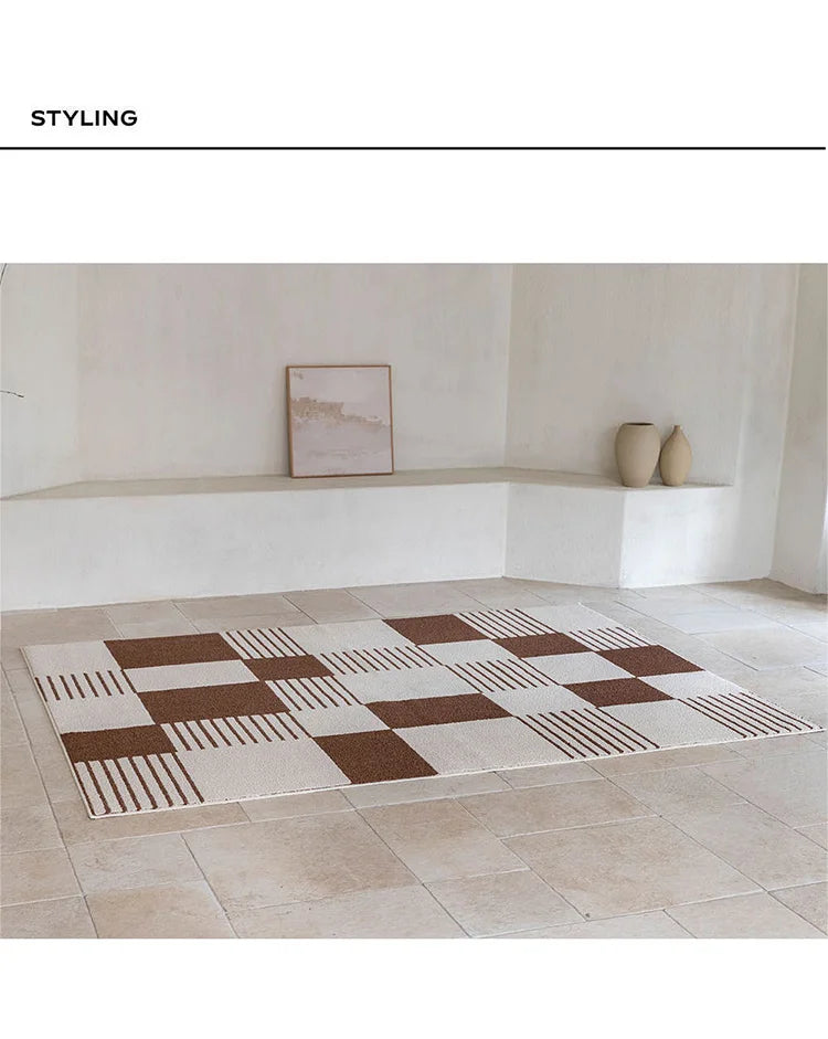 Checkered area rug with brown and beige pattern on a tiled floor.
