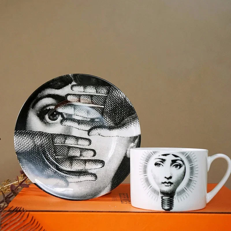 Decorative plate and mug with artistic designs on a brown surface