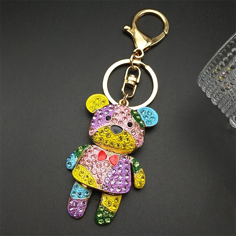 Colorful teddy bear keychain with rhinestones on a dark background