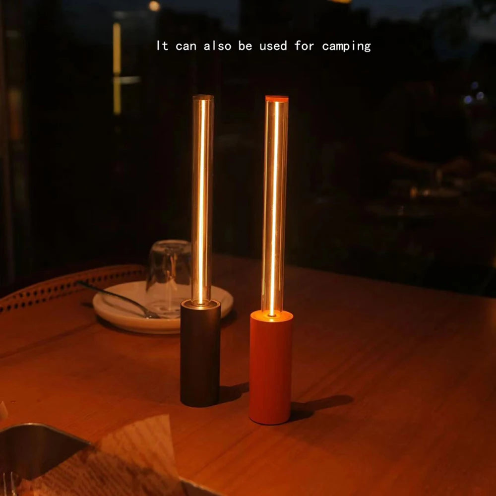 Two cylindrical lights on a table with a dark background