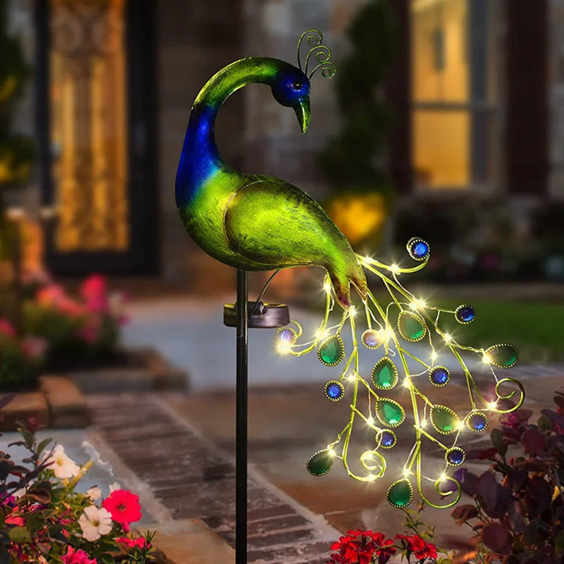 Decorative peacock solar light with LED lights in a garden setting