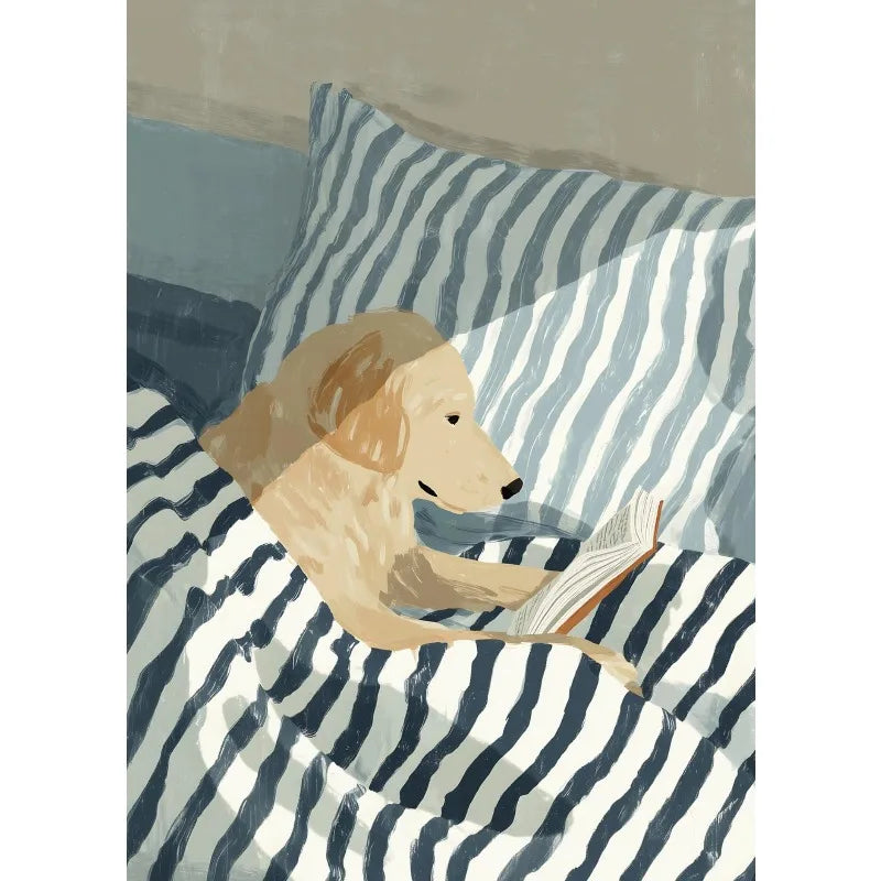 Dog reading a book on a striped pillow and blanket
