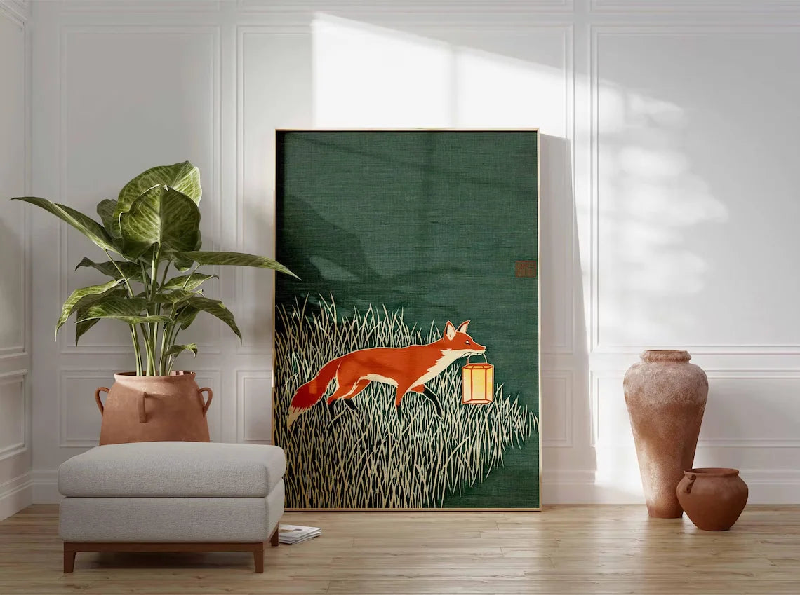 Minimalist Japanese-inspired fox art print showing an orange fox carrying a lantern through tall grass against a deep green background in a natural wood frame.