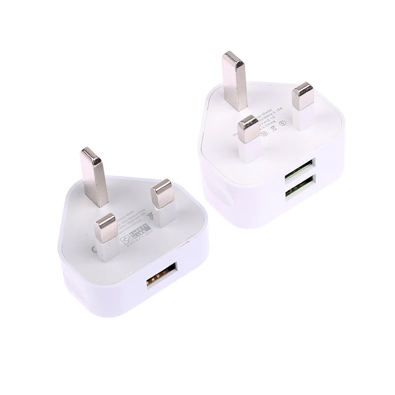 Two white USB wall adapters with UK plug on a white background