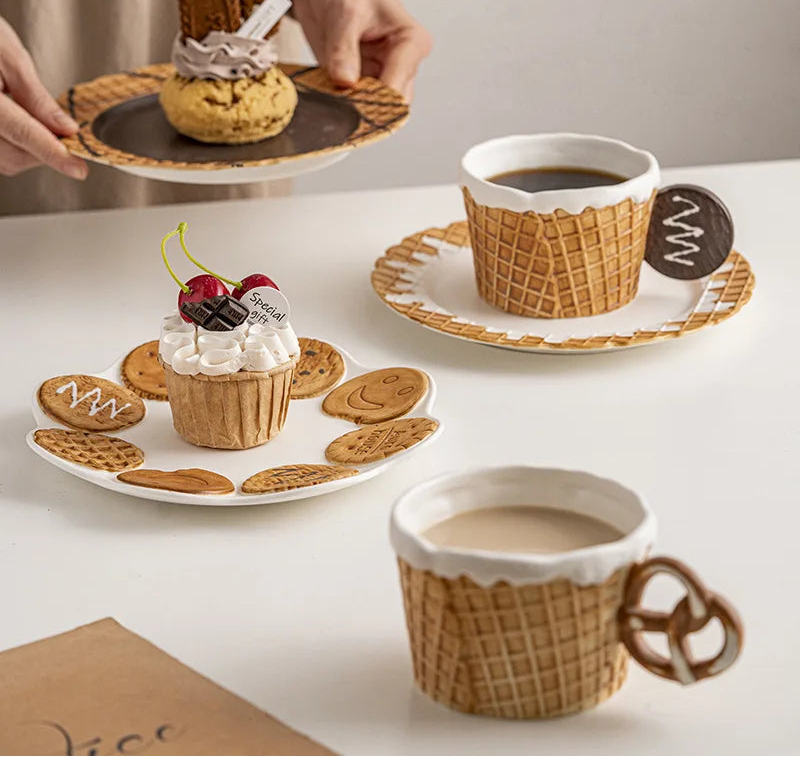 Ceramic waffle mugs and matching dessert plates displayed with coffee, cakes and biscuits for a stylish afternoon tea setting.